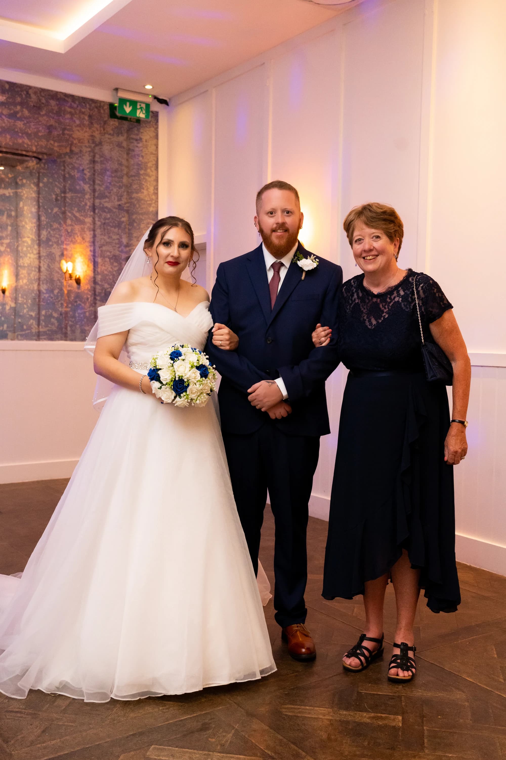 Ineta and Steve celebrating with a wedding guest
