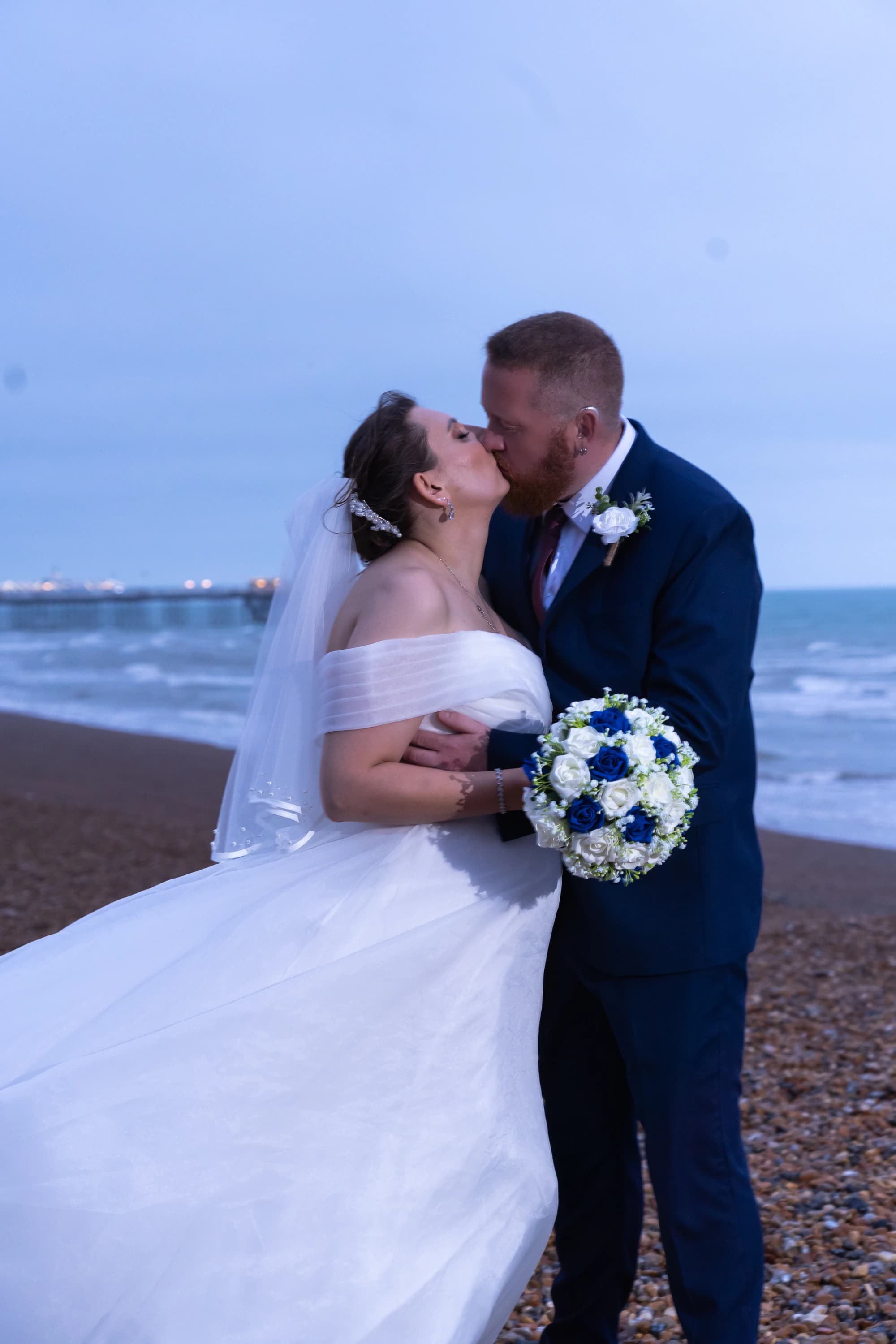 Ineta and Steve kissing by the sea