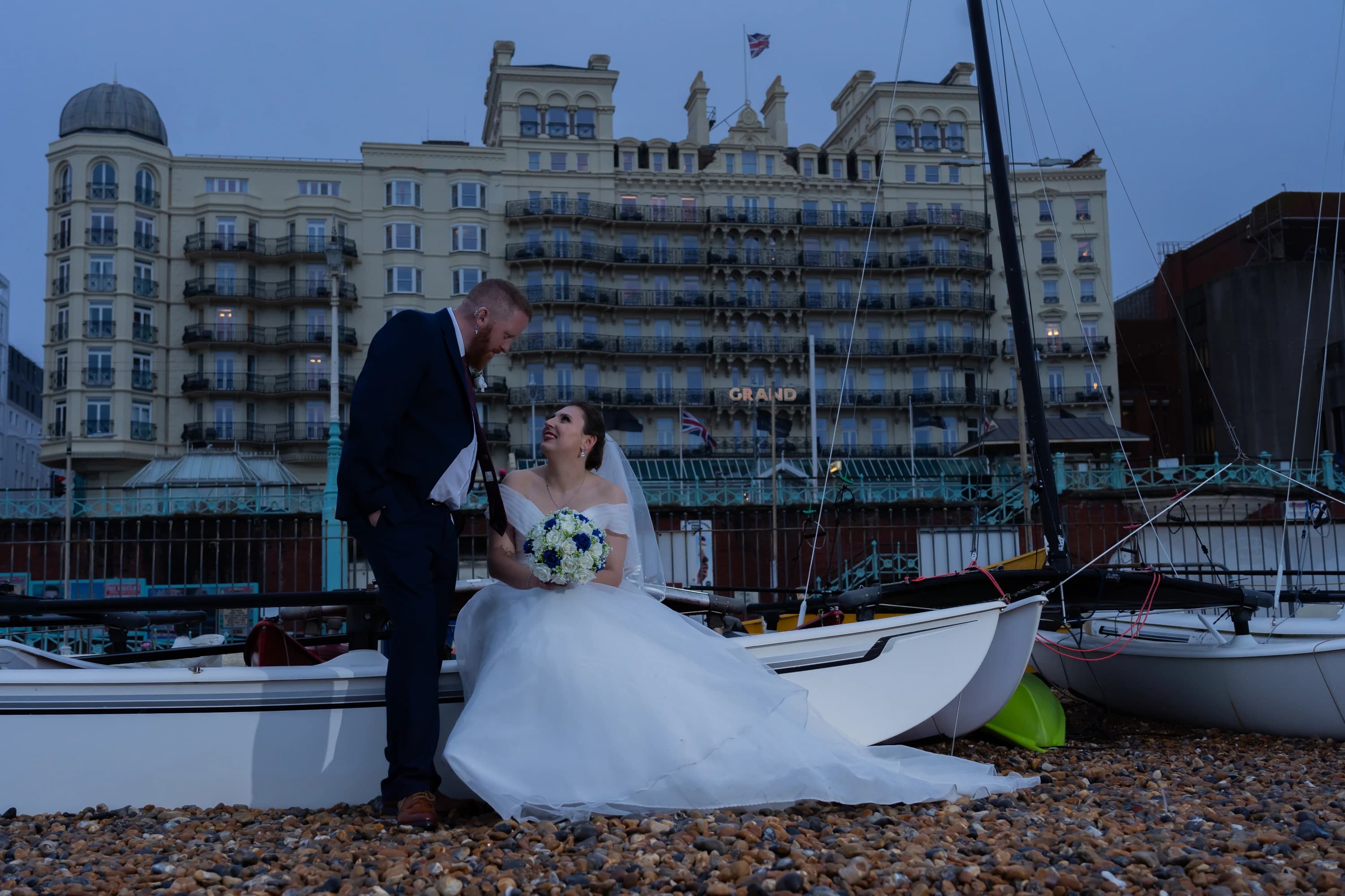Ineta and Steve beside the boats after their ceremony